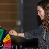 Event attendee spinning prize wheel